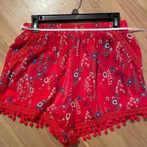 Red chiffon lined floral shorts//pom pom hem detail with pockets & elastic waist